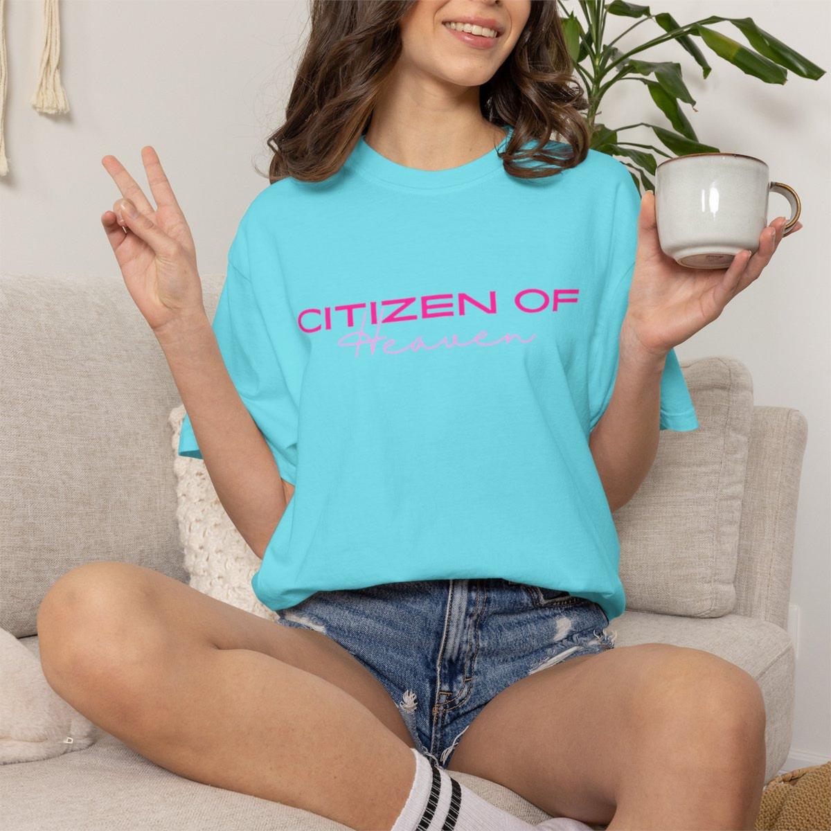 A blue t-shirt with the words Citizen of heaven in bright pink lettering 