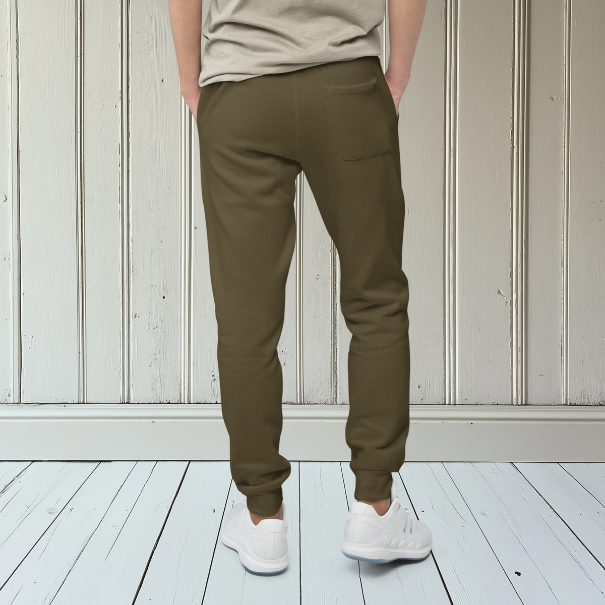 A pair of fleece lined mid rise skinny leg sweatpants with an embroidered silver dove carrying a fig leaf over the left front pocket of the pants.