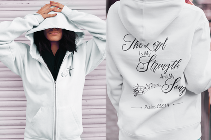 On the front of this Christian zip up hoodie is an image of a Jesus cross with music notes coming from the top of the cross, on the back of the hoodie are the words 'The Lord is my strength and my song Psalms 118:14 with music notes on either side of the image.