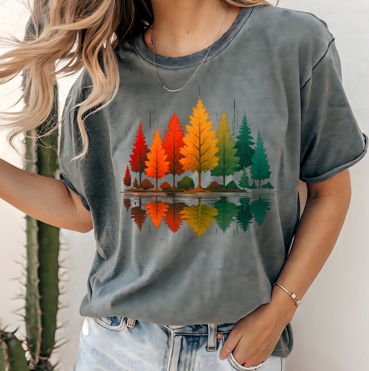 A oversized custom t-shirt with a vibrant image of fall trees that are reflecting over water.