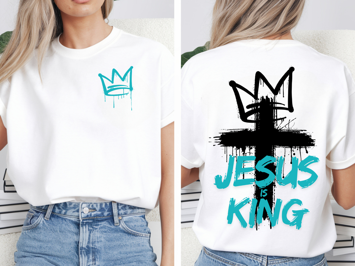 A oversized graphic t-shirt with an image of a crown spray painted on the top right chest of the shirt, on the back of the shirt is a large cross spray painted on the back with a cross on the top with the words 'Jesus is King' spray painted on the top.