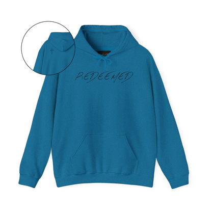 A blue hoodie with the words redeemed on the front center, a Jesus cross is on the back left shoulder of the hoodie.