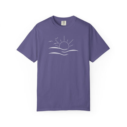 an oversized purple t-shirt the image on the front is a simple line drawing of waves and a sun with birds flying around the sun.