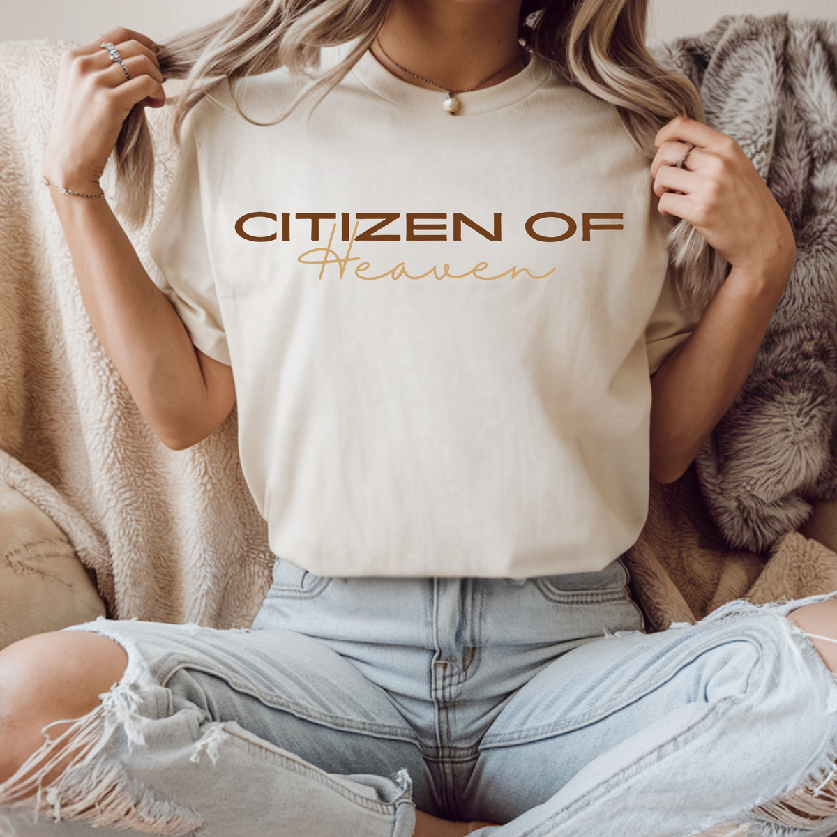 On the front of this ivory colored t-shirt are the words Citizen of Heaven in brown wording