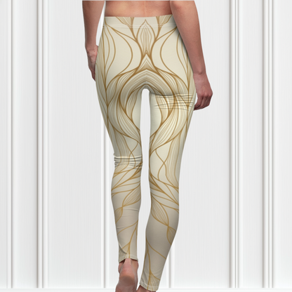 A pair of women's high waisted leggings, they are beige in color with abstract gold lines all over the pants.