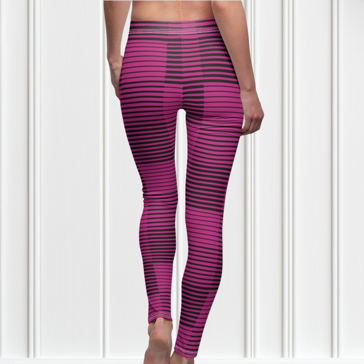 A pair of  hot pink with black stripes high waisted leggings with a white Jesus cross on the right ankle of the pants.