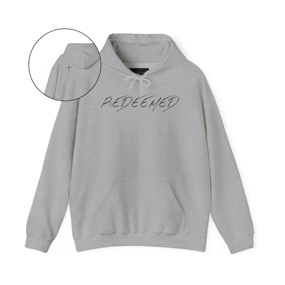 A grey hoodie with the words redeemed on the front center, a Jesus cross is on the back left shoulder of the hoodie.