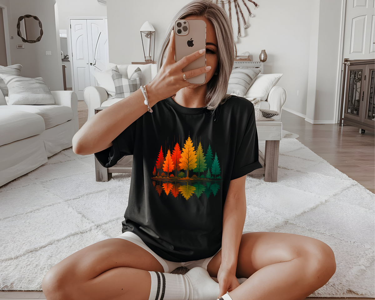 A oversized custom t-shirt with a vibrant image of fall trees that are reflecting over water.