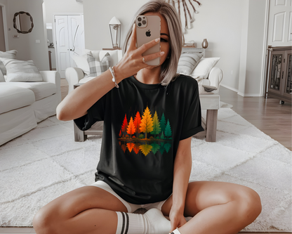 A oversized custom t-shirt with a vibrant image of fall trees that are reflecting over water.