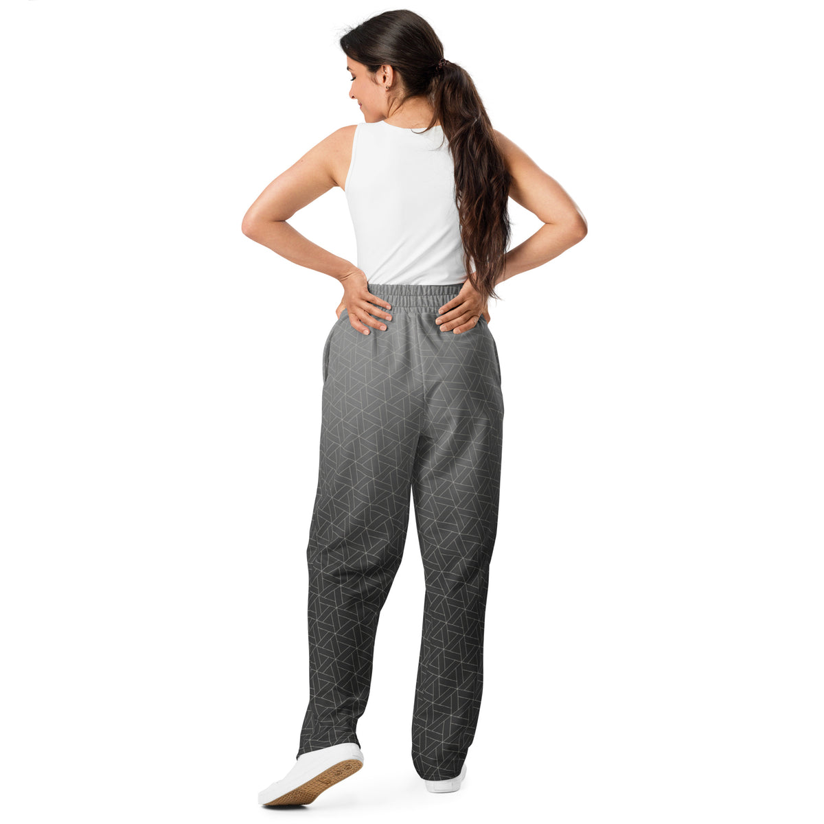 A pair of wide leg sweatpants that are grey ombre in color with a white diamond pattern overlayed on the top.