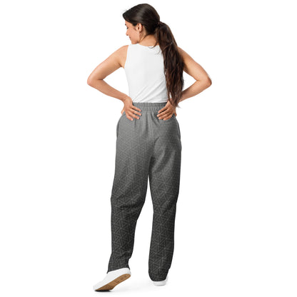 A pair of wide leg sweatpants that are grey ombre in color with a white diamond pattern overlayed on the top.