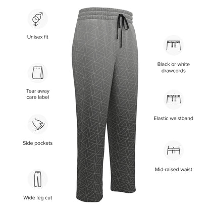 A pair of wide leg sweatpants that are grey ombre in color with a white diamond pattern overlayed on the top.