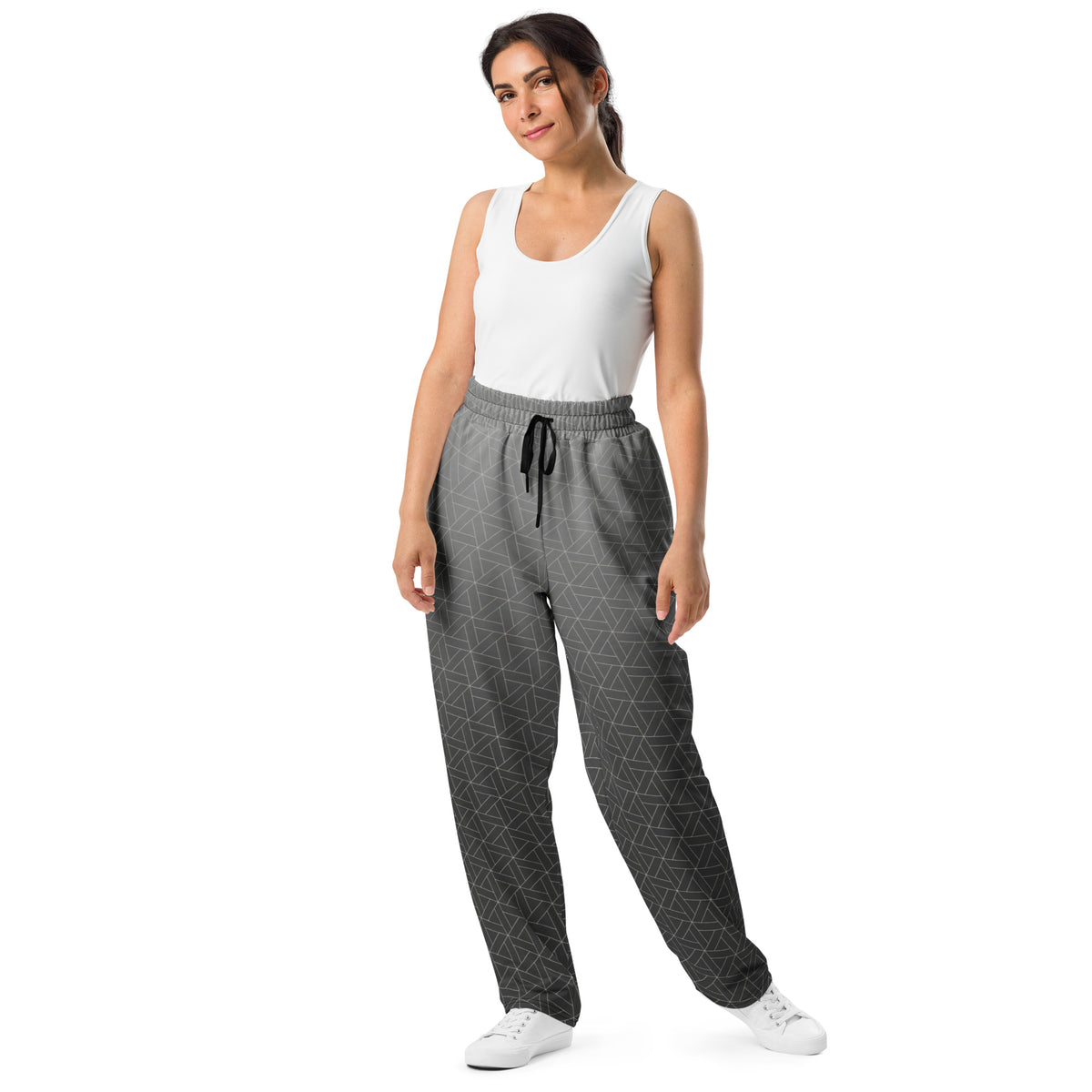 A pair of wide leg sweatpants that are grey ombre in color with a white diamond pattern overlayed on the top.