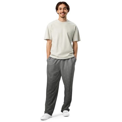 A pair of wide leg sweatpants that are grey ombre in color with a white diamond pattern overlayed on the top.