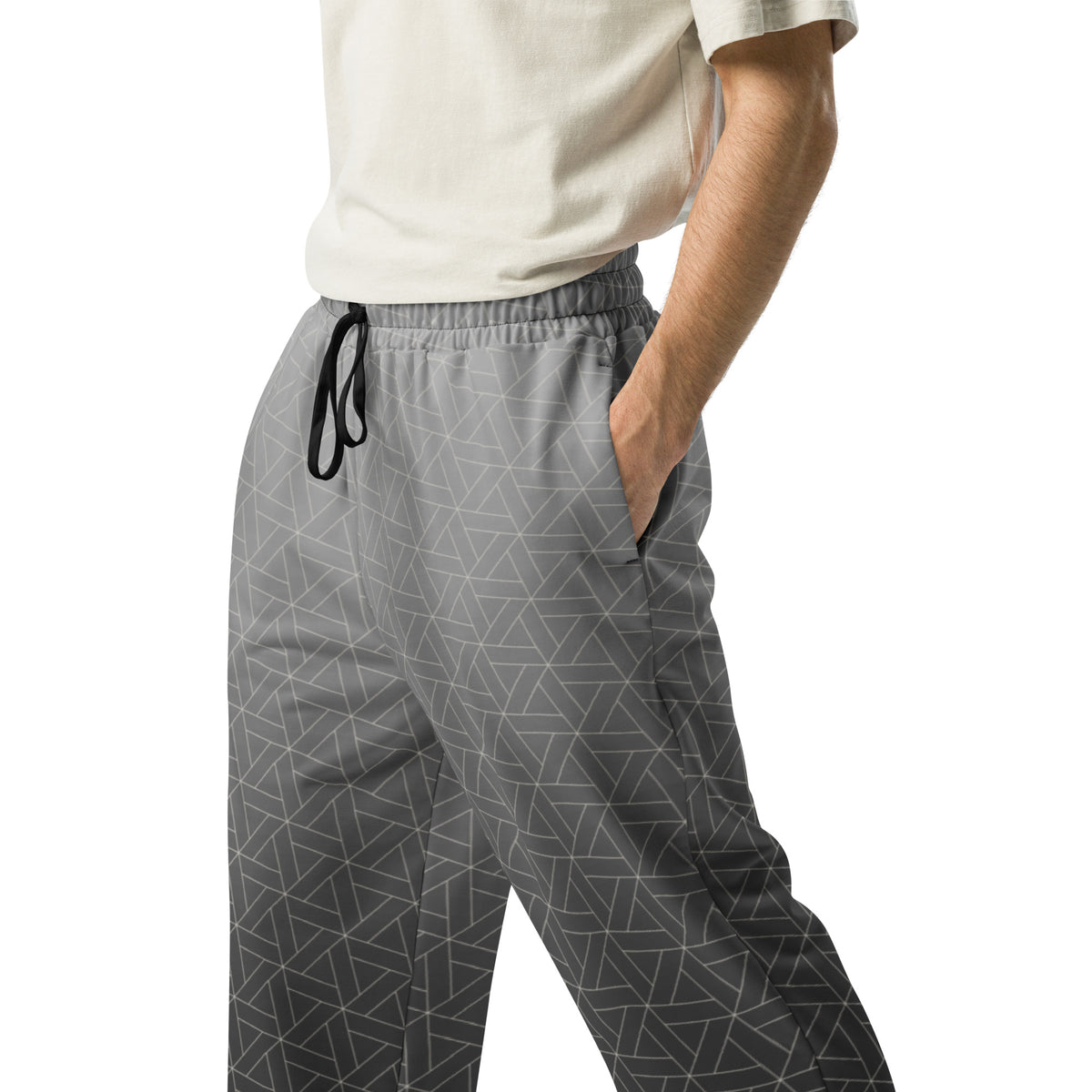A pair of wide leg sweatpants that are grey ombre in color with a white diamond pattern overlayed on the top.