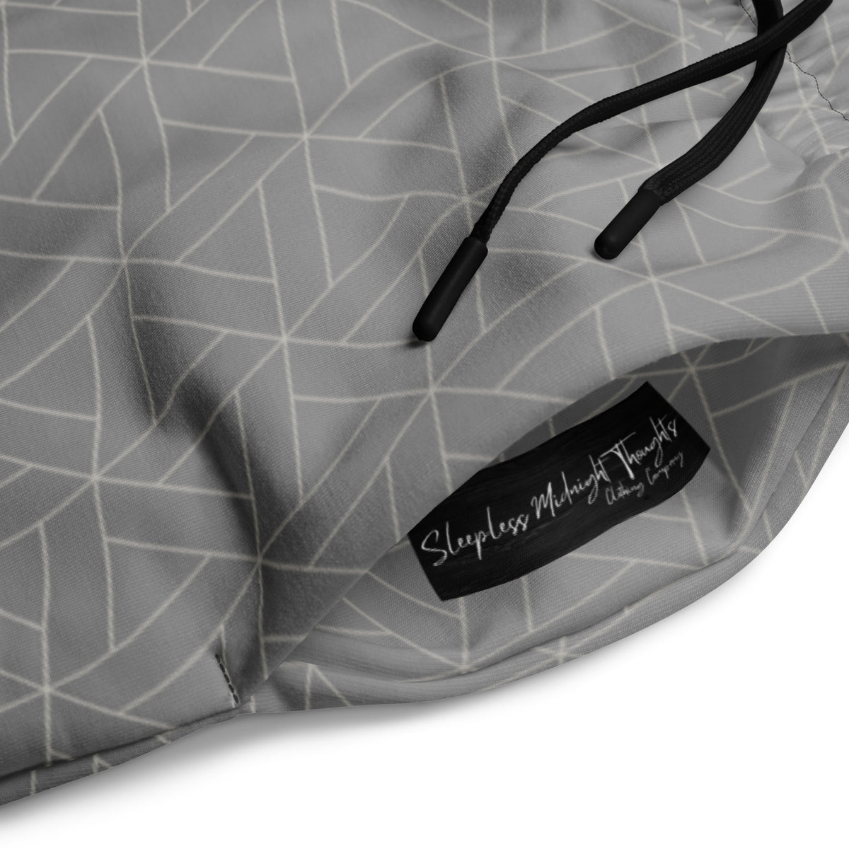 A pair of wide leg sweatpants that are grey ombre in color with a white diamond pattern overlayed on the top.