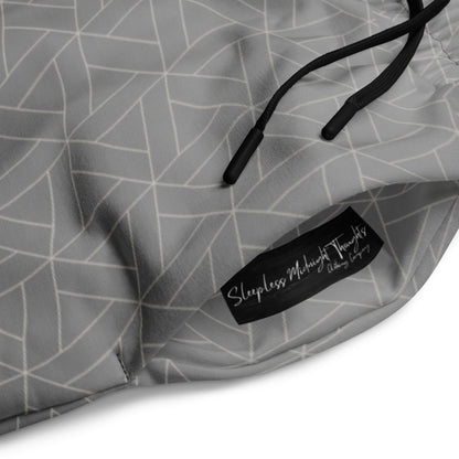 A pair of wide leg sweatpants that are grey ombre in color with a white diamond pattern overlayed on the top.
