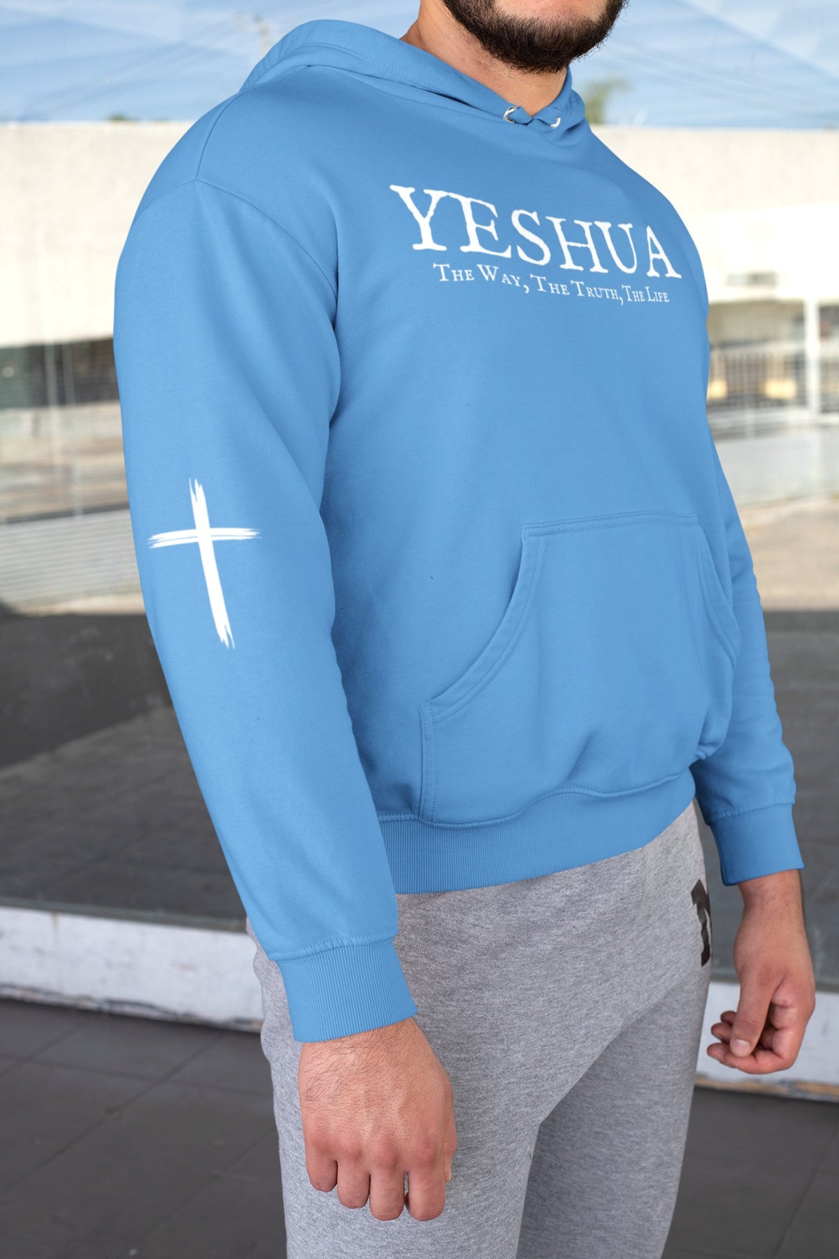 On the front of this Christian hoodie are the words 'Yeshua the way the truth the life' there is a Jesus cross on both sleeves of the hoodie.