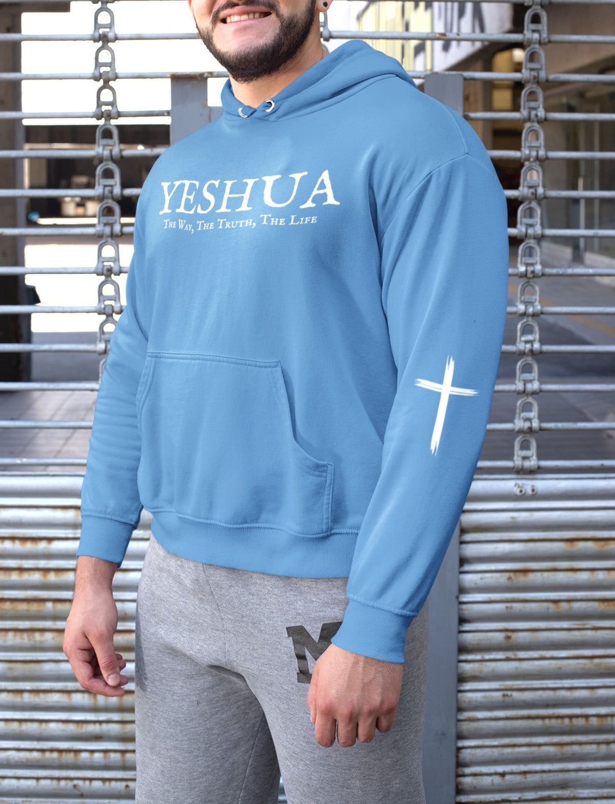 On the front of this Christian hoodie are the words 'Yeshua the way the truth the life' there is a Jesus cross on both sleeves of the hoodie.
