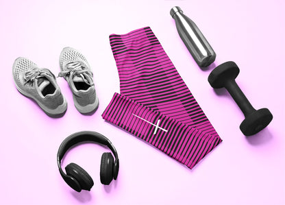 A pair of  hot pink with black stripes high waisted leggings with a white Jesus cross on the right ankle of the pants.