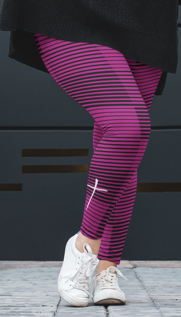A woman wearing hot pink with black stripes high waisted leggings with a white Jesus cross on the right ankle of the pants.