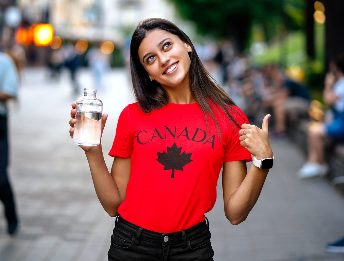 A red t-shirt with a maple leaf on the front and 'Canada' in large letters overtop of the maple leaf.