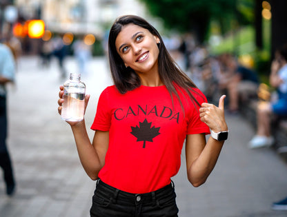 A red t-shirt with a maple leaf on the front and 'Canada' in large letters overtop of the maple leaf.