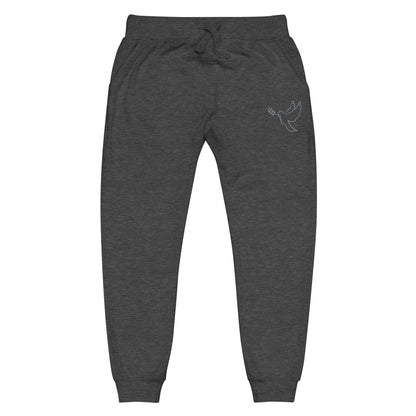 A pair of fleece lined mid rise skinny leg sweatpants with an embroidered silver dove carrying a fig leaf over the left front pocket of the pants.