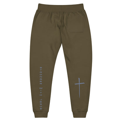 A pair of fleece lined sweatpants that have the words Stronger With Jesus on the back left leg of the pants, on the right leg is a large Jesus cross