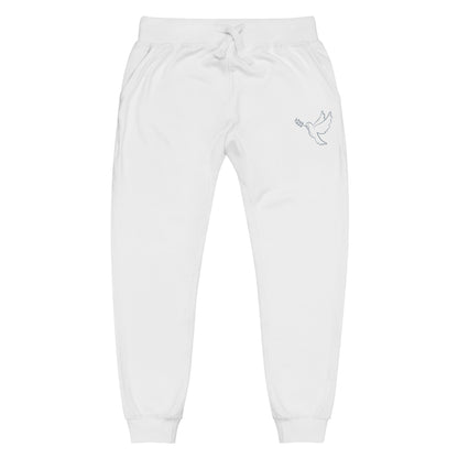A pair of fleece lined mid rise skinny leg sweatpants with an embroidered silver dove carrying a fig leaf over the left front pocket of the pants.